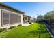 Landscaped backyard with artificial turf and a covered patio at 16925 W Virginia Ave, Goodyear, AZ 85395