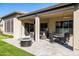 Covered patio with seating area and fire pit in the backyard at 16925 W Virginia Ave, Goodyear, AZ 85395
