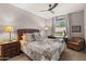 Comfortable bedroom with a queen-size bed, nightstand, and seating area at 16925 W Virginia Ave, Goodyear, AZ 85395
