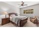 Serene bedroom with a wooden bed frame and a ceiling fan at 16925 W Virginia Ave, Goodyear, AZ 85395