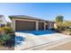 Two-car garage, desert landscaping, and neutral-colored exterior at 16925 W Virginia Ave, Goodyear, AZ 85395