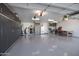Spacious garage with storage cabinets, workbench, and epoxy flooring at 16925 W Virginia Ave, Goodyear, AZ 85395