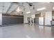 Large garage featuring ample storage, a workbench, and a refrigerator at 16925 W Virginia Ave, Goodyear, AZ 85395