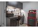 Organized garage workshop with tool storage and workbench at 16925 W Virginia Ave, Goodyear, AZ 85395