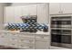 White kitchen with stainless steel appliances and a gas cooktop at 16925 W Virginia Ave, Goodyear, AZ 85395