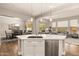 Open concept kitchen with island, stainless steel appliances, and hardwood floors at 16925 W Virginia Ave, Goodyear, AZ 85395