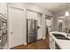 Modern kitchen with stainless steel appliances and white cabinetry at 16925 W Virginia Ave, Goodyear, AZ 85395