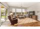 Spacious living room with hardwood floors, leather furniture, and large windows at 16925 W Virginia Ave, Goodyear, AZ 85395