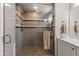 Modern shower with glass enclosure, tile surround, and built-in seat at 16925 W Virginia Ave, Goodyear, AZ 85395