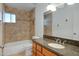 Bathroom with granite countertop, wood cabinets, and tile shower at 17112 E La Pasada Dr, Fountain Hills, AZ 85268