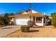 House exterior showcasing a brown roof, white walls, and a neatly landscaped front yard at 18438 N 19Th St, Phoenix, AZ 85022