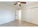 Bright bedroom with ceiling fan, wood-look floors, and ample closet space at 2328 E Laurel Ln, Phoenix, AZ 85028