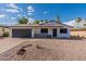 Newly renovated home with a dark gray garage door at 2328 E Laurel Ln, Phoenix, AZ 85028