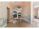 Formal entry hall with hand painted walls and a crystal chandelier at 26485 N 108Th Way, Scottsdale, AZ 85255