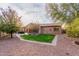 Landscaped backyard with a hot tub and pergola at 30213 N 124Th Ln, Peoria, AZ 85383