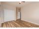 Bedroom with wood-look floors and double closet doors at 30213 N 124Th Ln, Peoria, AZ 85383