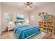 Cozy bedroom with ceiling fan, natural light, stylish furniture, modern bed, and bright colors at 30213 N 124Th Ln, Peoria, AZ 85383