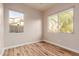 Bedroom with wood-look floors and two windows at 30213 N 124Th Ln, Peoria, AZ 85383
