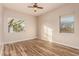 Bright bedroom with wood-look floors and ceiling fan at 30213 N 124Th Ln, Peoria, AZ 85383