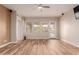 Living room featuring hardwood floors and sliding door access to patio at 30213 N 124Th Ln, Peoria, AZ 85383