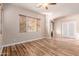 Bright living room featuring hardwood floors and multiple windows at 30213 N 124Th Ln, Peoria, AZ 85383