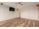 Spacious living room with hardwood floors and a mounted TV at 30213 N 124Th Ln, Peoria, AZ 85383
