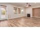 Living room with hardwood floors, fireplace and door to patio at 30213 N 124Th Ln, Peoria, AZ 85383
