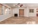 Living room with hardwood floors, fireplace and kitchen view at 30213 N 124Th Ln, Peoria, AZ 85383