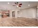 Spacious living room with hardwood floors and kitchen access at 30213 N 124Th Ln, Peoria, AZ 85383