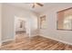 Spacious office with wood-look floors and access to another room at 30213 N 124Th Ln, Peoria, AZ 85383