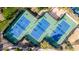 Aerial view of well-lit tennis courts at 30213 N 124Th Ln, Peoria, AZ 85383