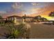 Luxury home exterior at sunset, featuring a large driveway and landscaping at 30409 N 142Nd St, Scottsdale, AZ 85262