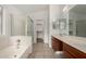 Spacious bathroom with double sinks, a soaking tub, and a walk-in shower at 3041 E Wahalla Ln, Phoenix, AZ 85050