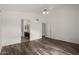 Spacious bedroom with wood-look flooring and access to bathroom at 3041 E Wahalla Ln, Phoenix, AZ 85050