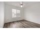 Well-lit bedroom featuring wood-look floors and ceiling fan at 3041 E Wahalla Ln, Phoenix, AZ 85050