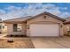 Light beige house with a two-car garage and small front yard at 3041 E Wahalla Ln, Phoenix, AZ 85050