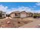 Single-story house with a two-car garage and rocky landscaping at 3041 E Wahalla Ln, Phoenix, AZ 85050