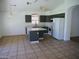Bright kitchen featuring an island, white appliances, tiled floors, and neutral countertops and cabinets at 3041 E Wahalla Ln, Phoenix, AZ 85050