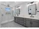 Clean bathroom with subway tile shower, double vanity, and patterned floors at 3322 N Valencia Ln, Phoenix, AZ 85018