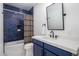 Bathroom with blue tile, white vanity, and hexagon floor tile at 3322 N Valencia Ln, Phoenix, AZ 85018