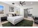 Serene bedroom with a king-size bed, barn door to bathroom, and workspace at 3322 N Valencia Ln, Phoenix, AZ 85018