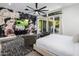 Bright bedroom with floral wall art, TV, and private balcony at 3322 N Valencia Ln, Phoenix, AZ 85018