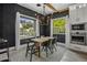 Dining room with a modern chandelier, a sleek table set, and a view of the outdoors through large windows at 3322 N Valencia Ln, Phoenix, AZ 85018