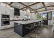A spacious kitchen with white cabinets, a large island with chairs, and modern stainless steel appliances at 3322 N Valencia Ln, Phoenix, AZ 85018