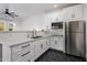 Small modern white kitchen with stainless steel appliances at 3322 N Valencia Ln, Phoenix, AZ 85018