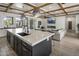 Open floor plan features a modern kitchen with large island flowing into the living area with fireplace at 3322 N Valencia Ln, Phoenix, AZ 85018