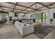 Open-concept living room with a decorative ceiling, large sofa, and seamless flow into the modern kitchen at 3322 N Valencia Ln, Phoenix, AZ 85018