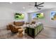 Cozy living room with green sofa, wood accent wall, and large TV at 3322 N Valencia Ln, Phoenix, AZ 85018