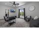 Bright office space with a modern desk, seating area, and a patio outside the glass doors at 3322 N Valencia Ln, Phoenix, AZ 85018