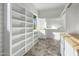 Bright walk-in closet with ample shelving and built-in drawers at 3322 N Valencia Ln, Phoenix, AZ 85018